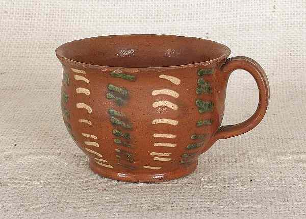 Appraisal: Pennsylvania redware mug th c with yellow and green slip