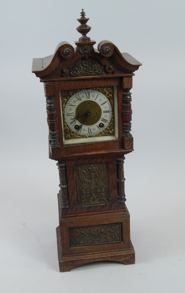 Appraisal: A miniature oak Continental longcase clock inset with various bronzed