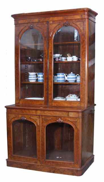 Appraisal: A VICTORIAN BURR WALNUT LIBRARY BOOKCASE the upper section enclosed