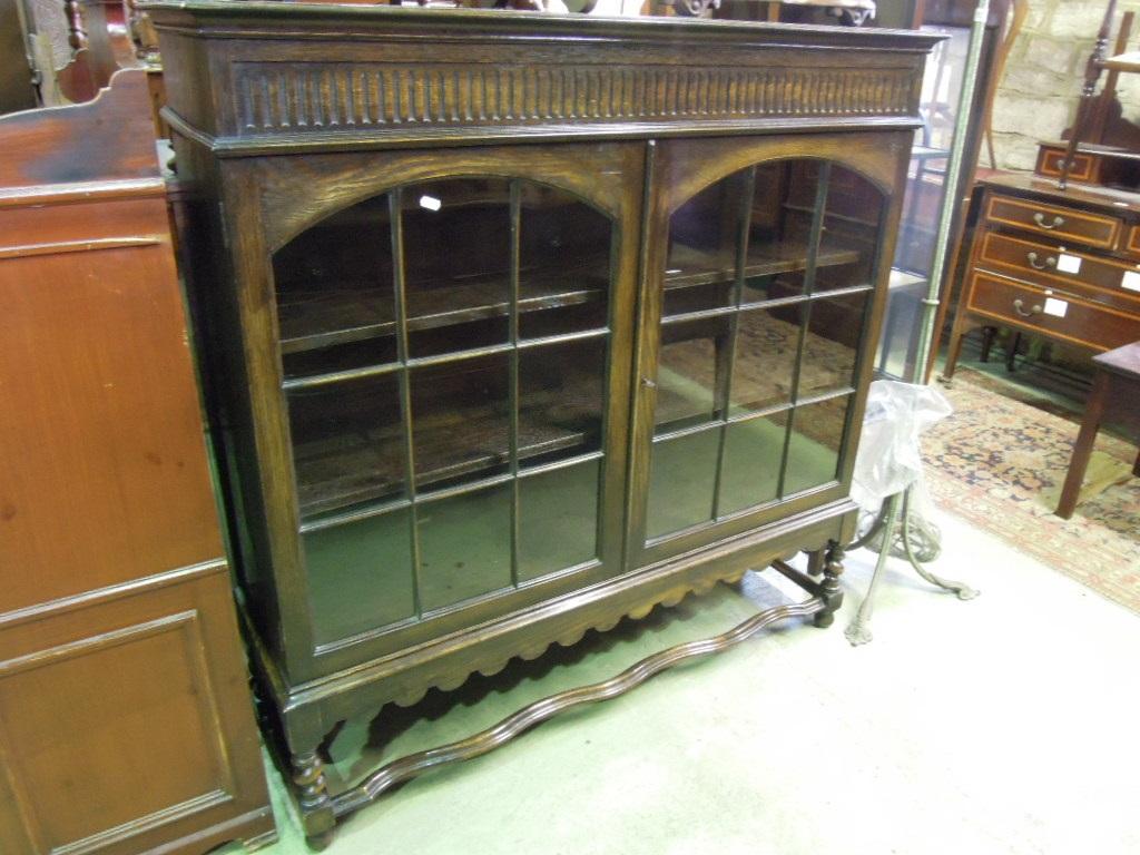 Appraisal: An Edwardian 's oak bookcase with fluted frieze over a