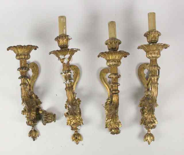 Appraisal: A set of four carved and gilded single-light wall lights