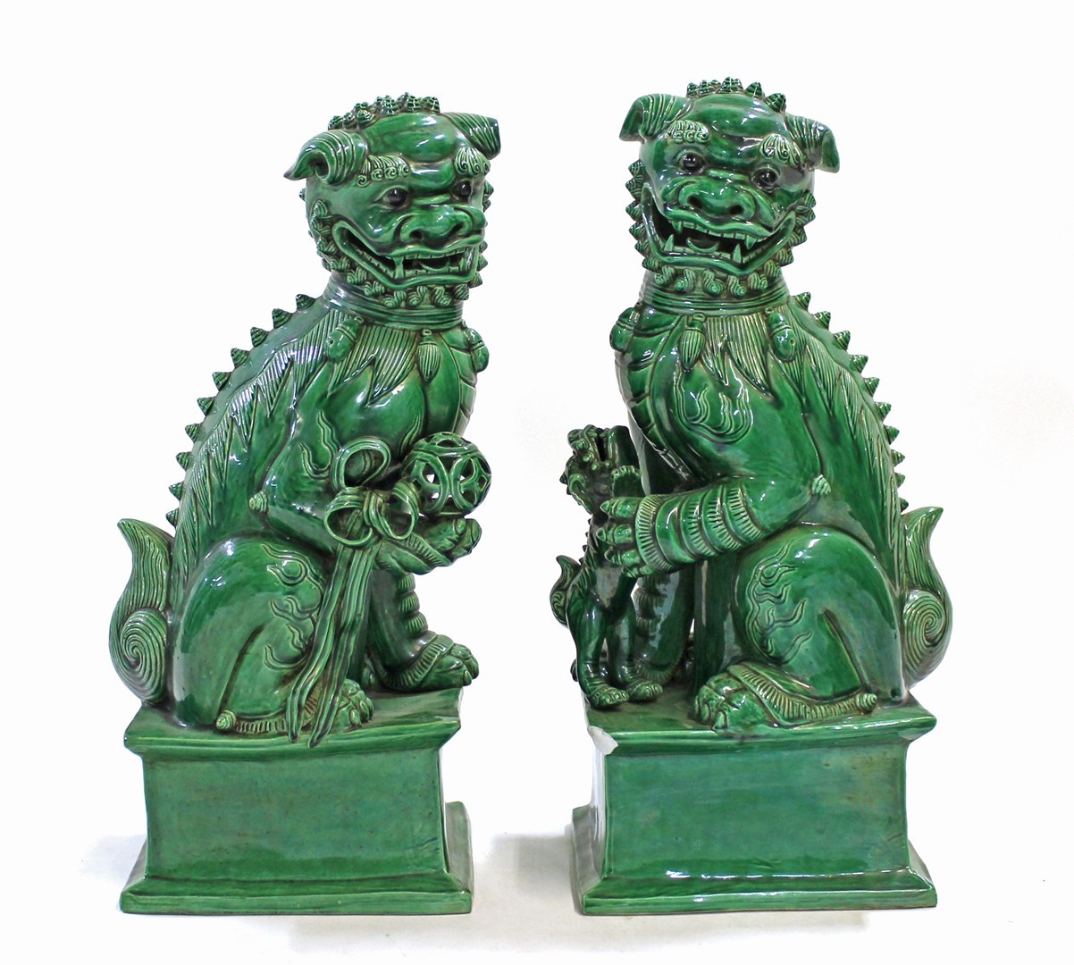 Appraisal: A pair of Chinese th century green glazed seated Buddhist