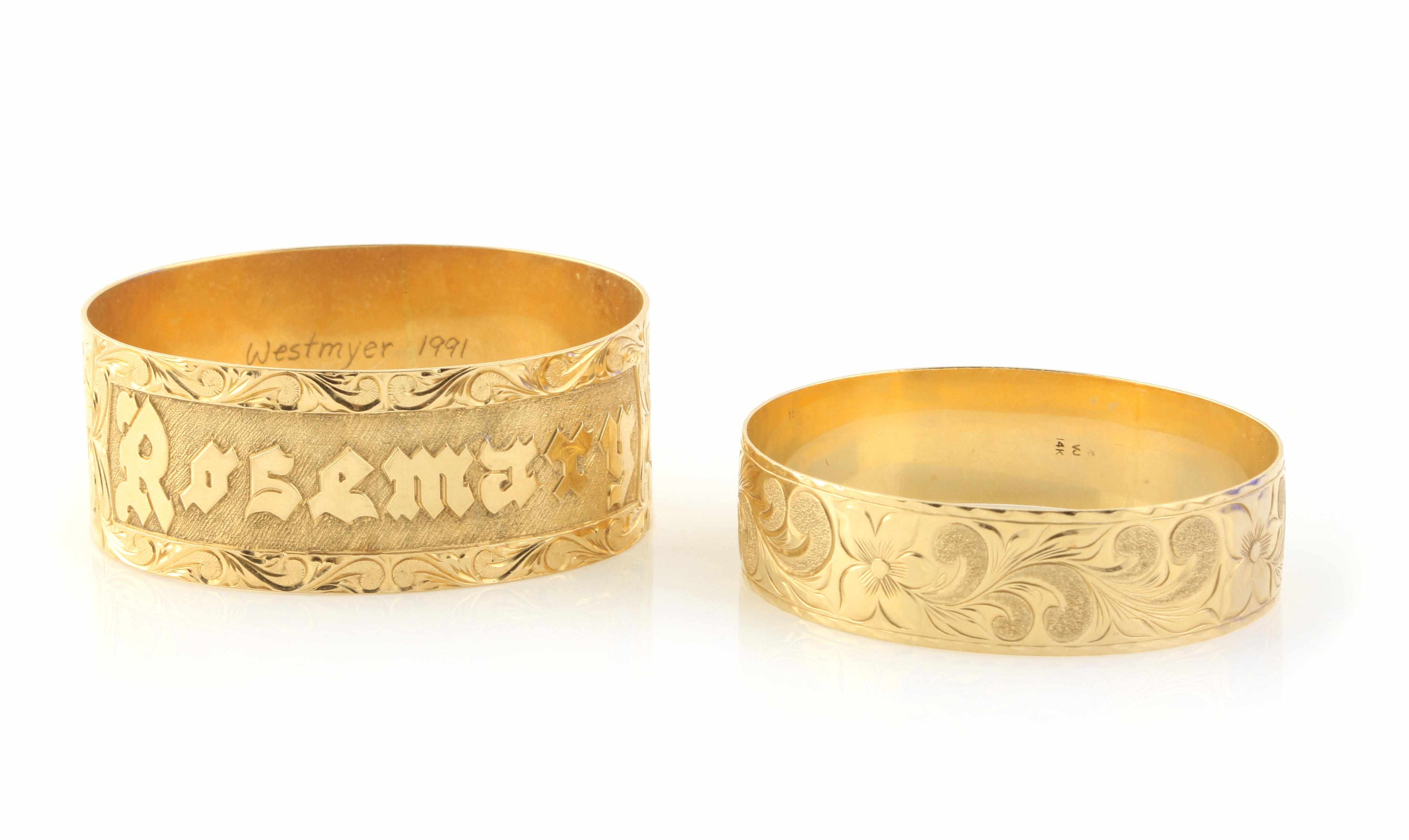 Appraisal: A pair of k gold engraved bangles g gross