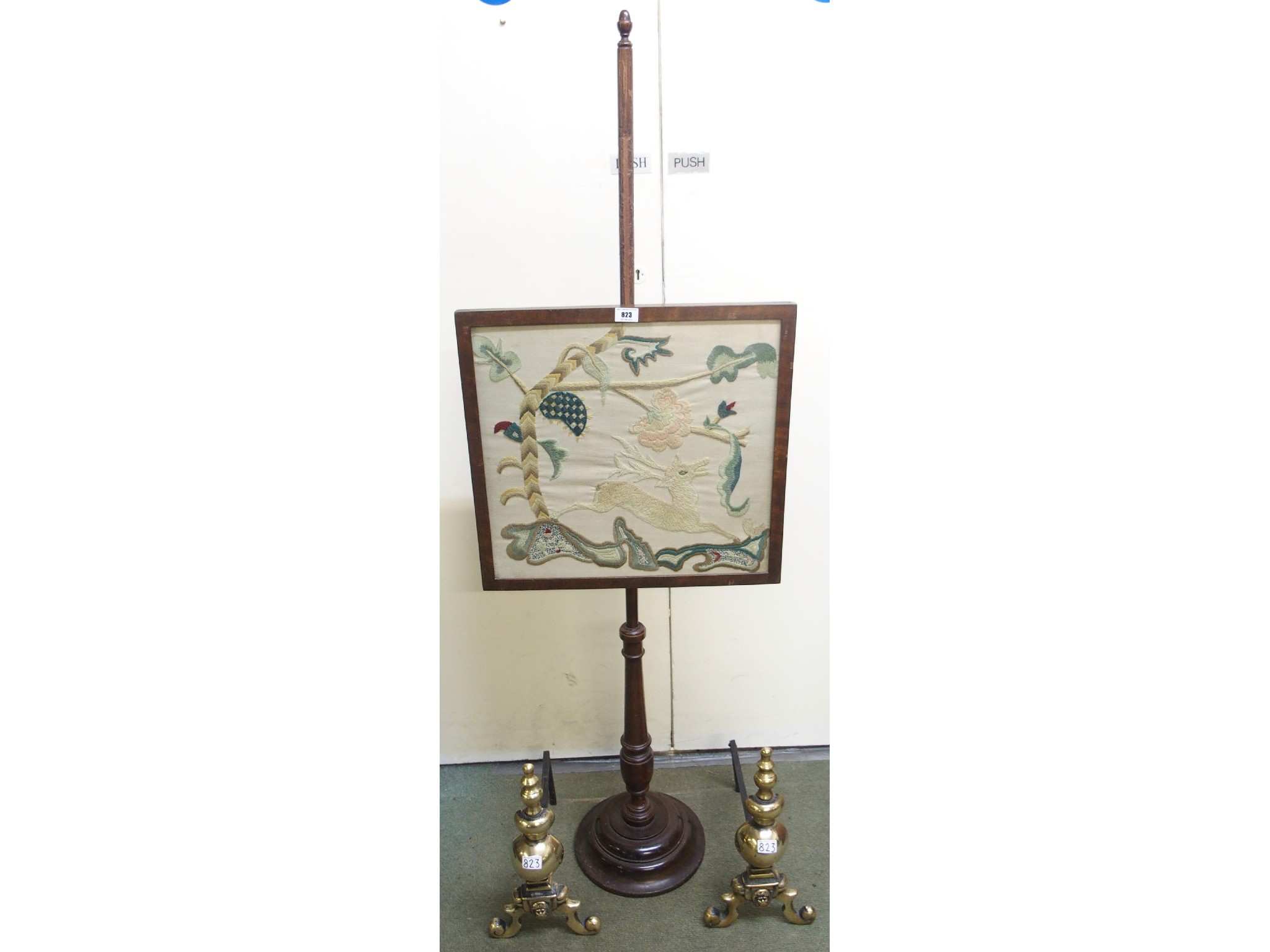 Appraisal: A tapestry pole screen and a pair of brass fire