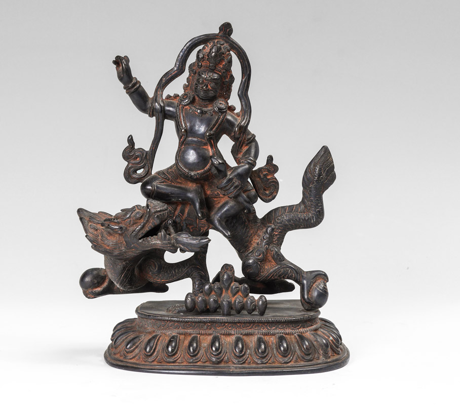 Appraisal: BRONZE BUDDHIST DEITY ON DRAGON Figure of Jambhala Buddhist God