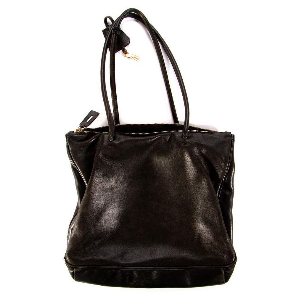 Appraisal: Prada black leather handbag measuring x in piping exposed at