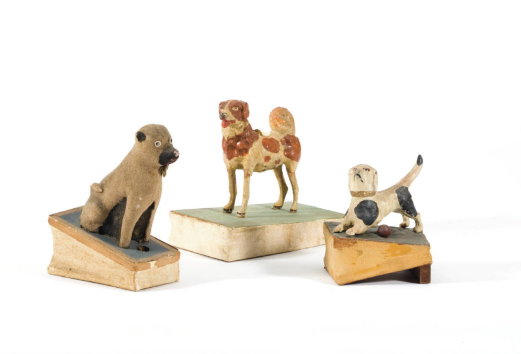 Appraisal: THREE PAINTED PAPIER MACHE OR COMPOSITION WOOD AND LEATHER DOG