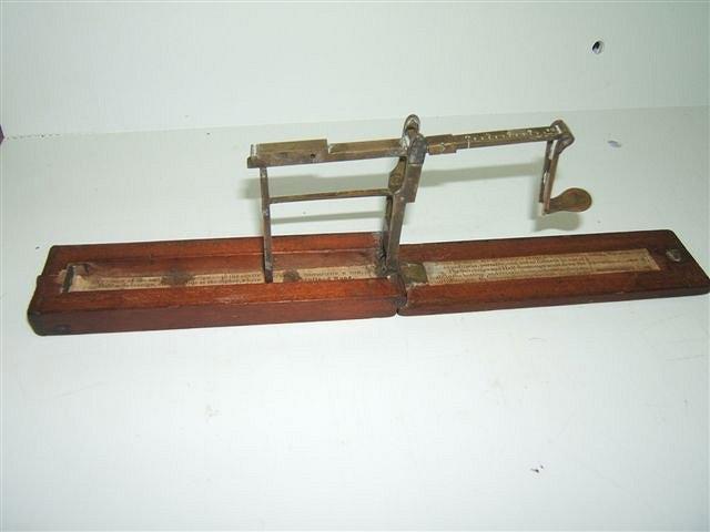 Appraisal: A GEORGE III MAHOGANY AND BRASS CASED GUINEA SCALE of