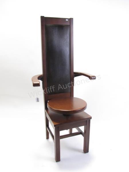 Appraisal: An antique dental patient's chair walnut with leather back rotating