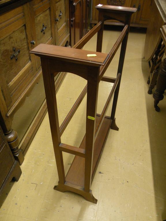 Appraisal: An Edwardian walnut towel rail