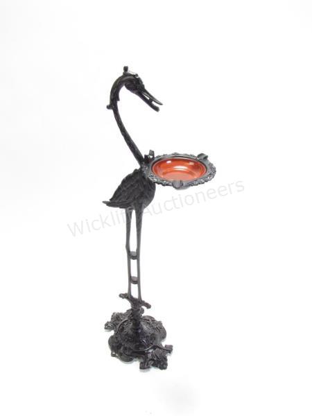 Appraisal: A wrought iron crane-motif floor standing ashtray with glass tray