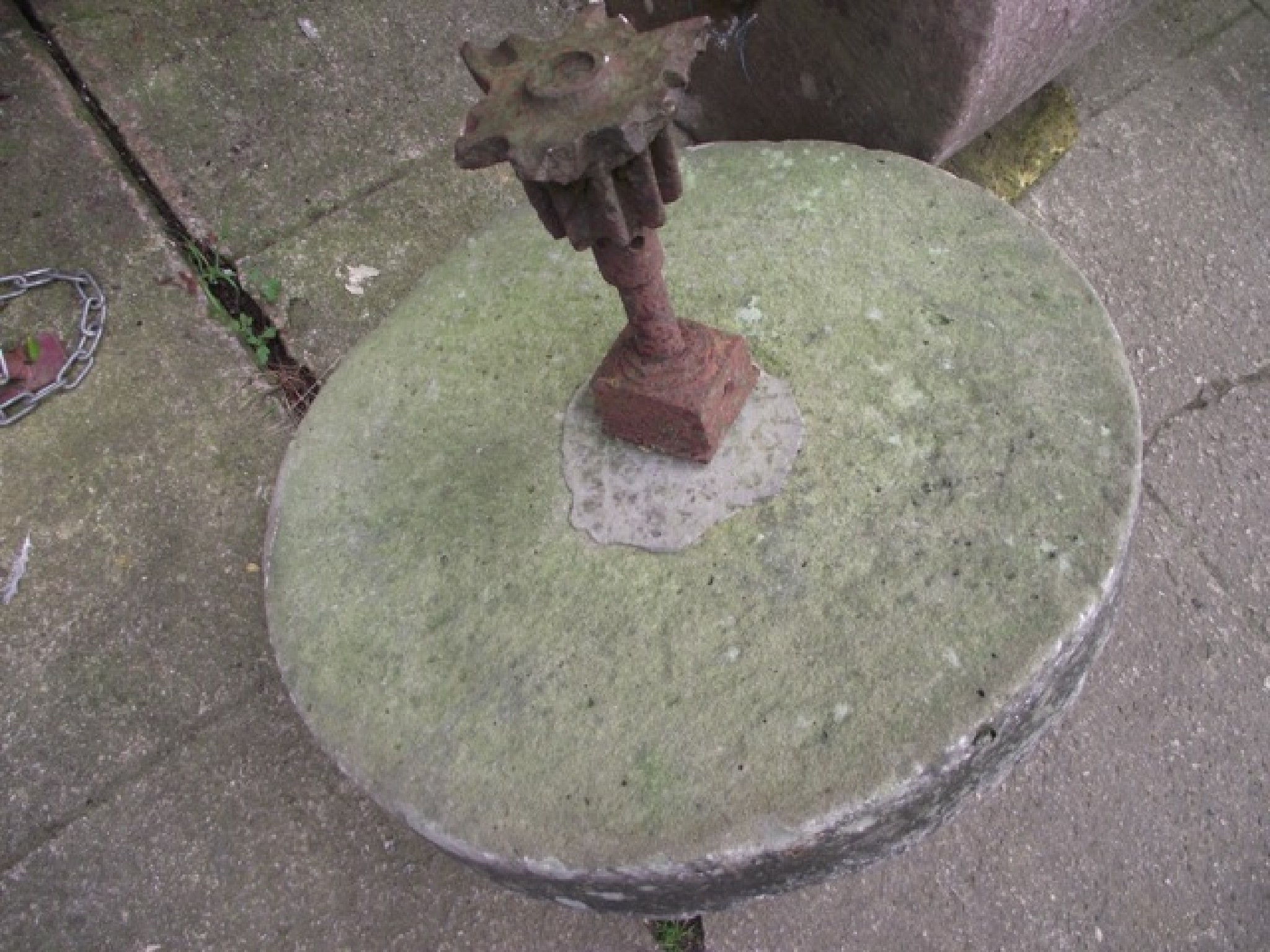 Appraisal: An old mill grinding stone with central cast iron shaft