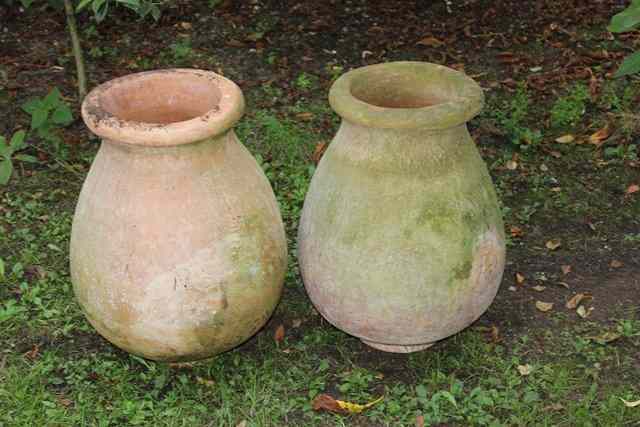 Appraisal: A PAIR OF OVOID TERRACOTTA JARS with flaring rims high