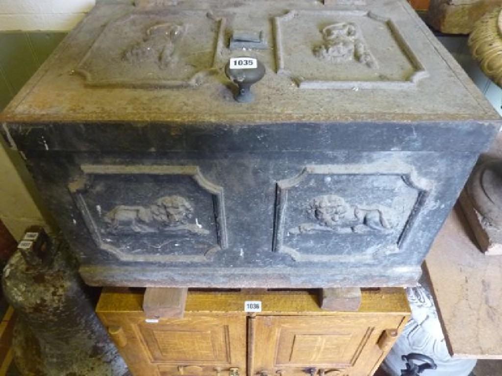 Appraisal: A th century cast iron strong box with decorative recumbent