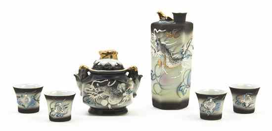 Appraisal: A Dragonware Sake Set comprising four cups with lithophane bases