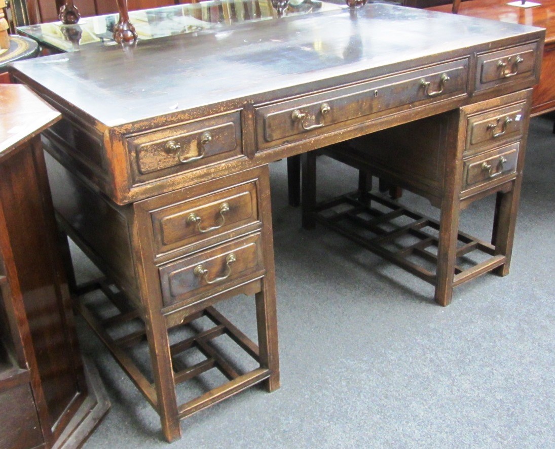 Appraisal: An early th century Chinese hardwood pedestal desk with seven