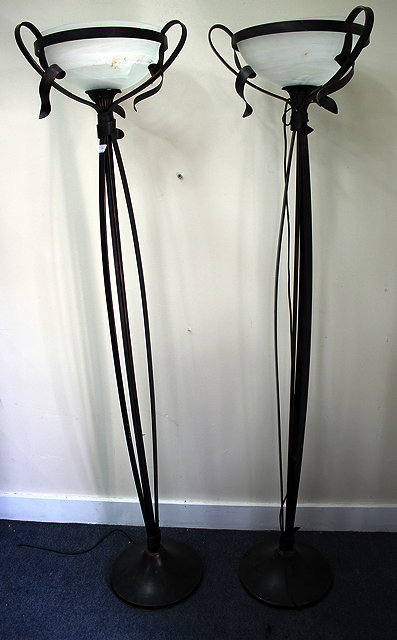 Appraisal: A PAIR OF PAINTED WROUGHT IRON FLOOR LAMPS with glass