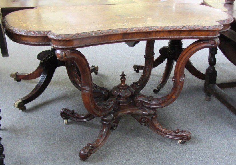 Appraisal: A Victorian marquetry inlaid figured walnut centre table on scroll