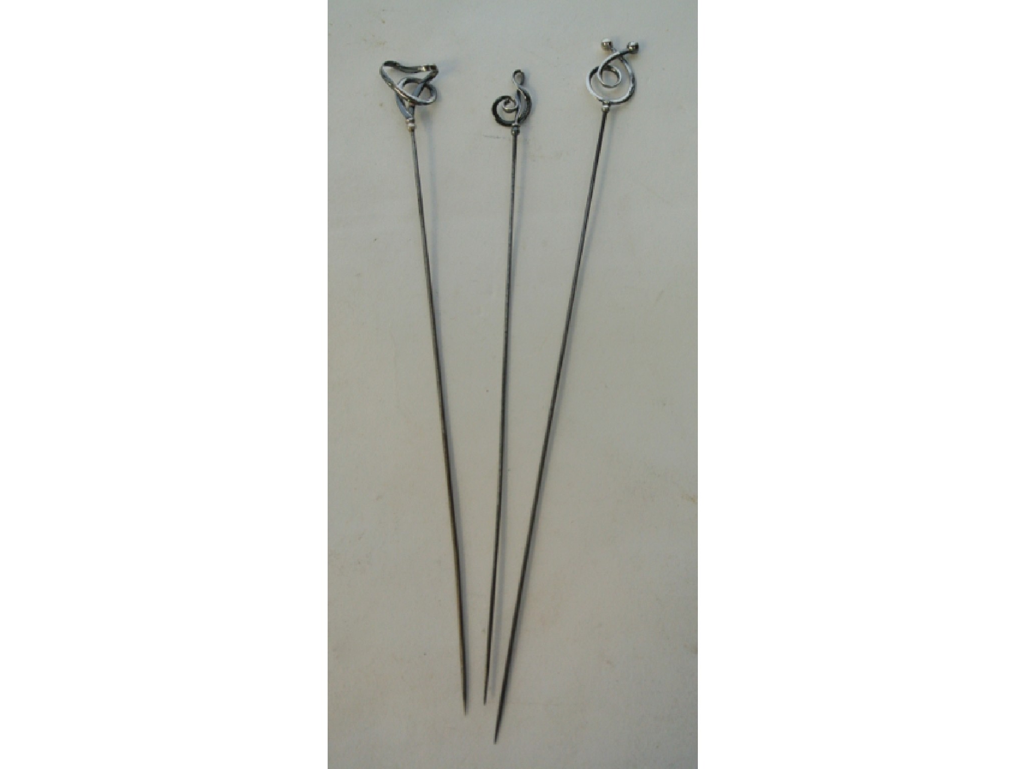 Appraisal: A collection of three silver hatpins Charles Horner - each