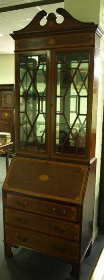 Appraisal: An Edwardian mahogany and satinwood crossbanded bureau bookcase the broken