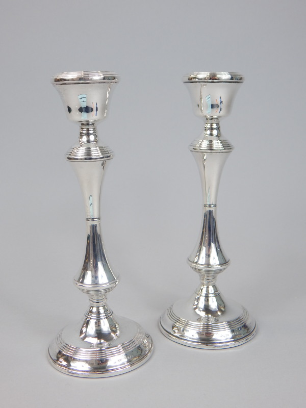 Appraisal: A pair of modern silver candlesticks each with reeded decoration