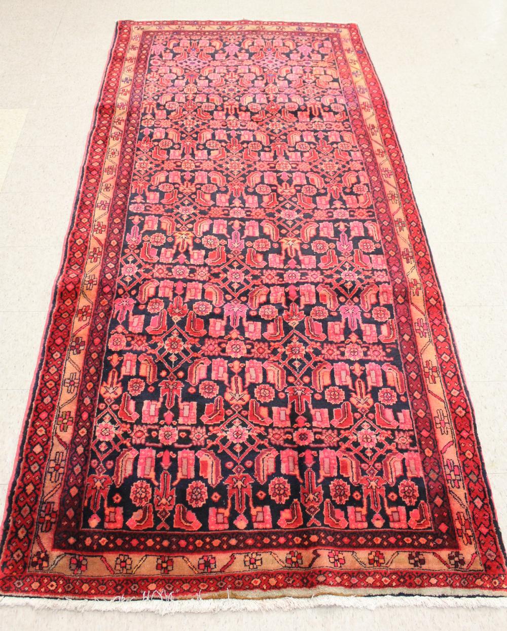 Appraisal: HAND KNOTTED PERSIAN AREA RUG repeating bands of stylized flowers