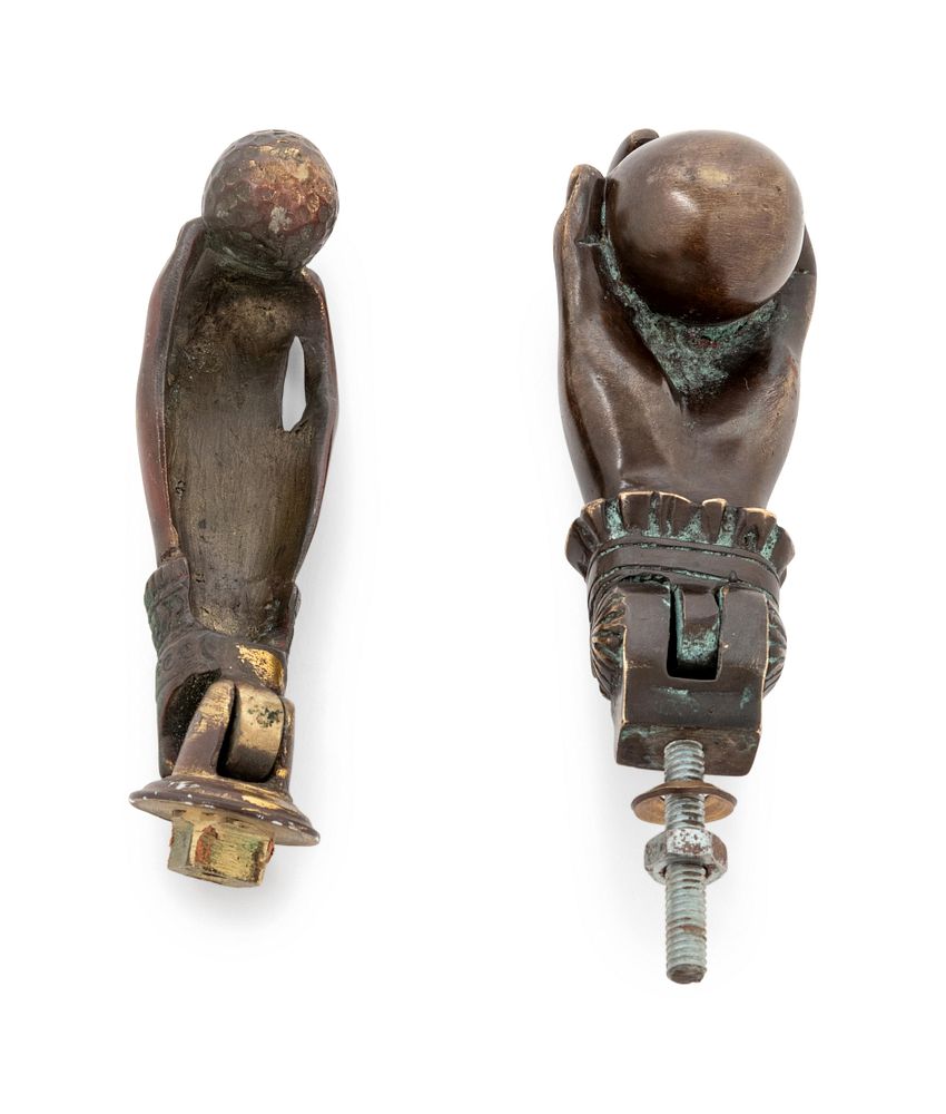 Appraisal: A Pair of Bronze Hand-and-Ball Door Knockers A Pair of