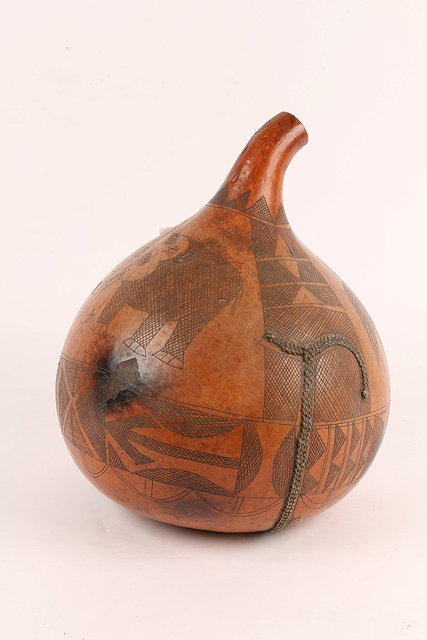 Appraisal: A KENYA WAKAMBA GOURD with incised carved bird snake and