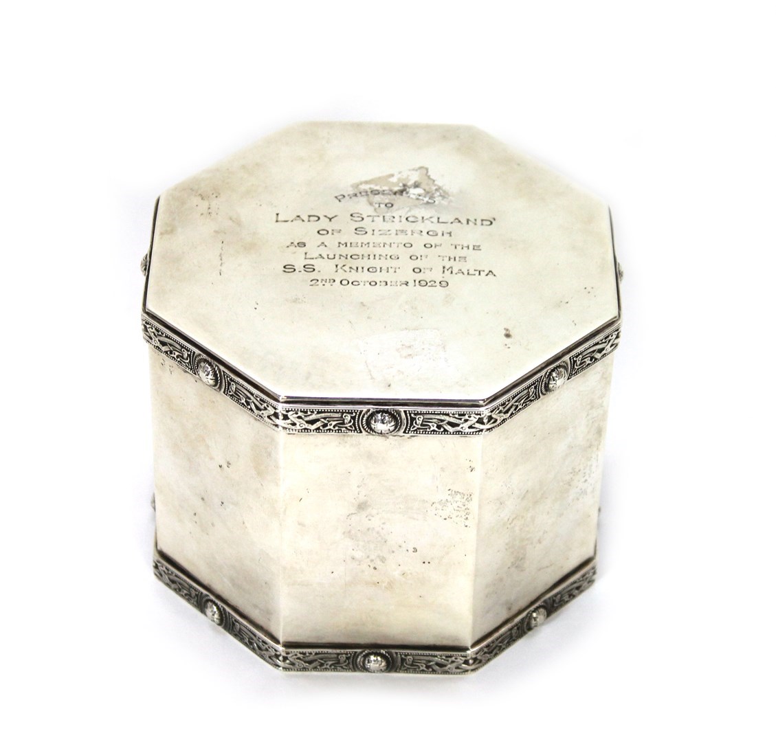 Appraisal: A silver octagonal hinge lidded biscuit barrel decorated with cast