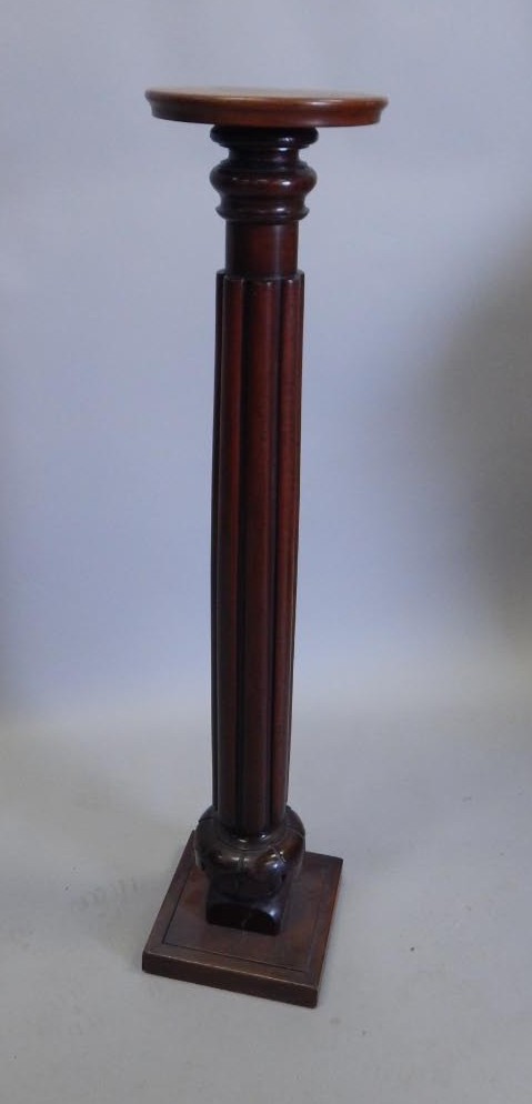 Appraisal: A mahogany torchere with a circular top and square base