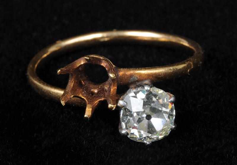 Appraisal: GOLD AND DIAMOND CROSSOVER RING Centering one old-mine cut diamond