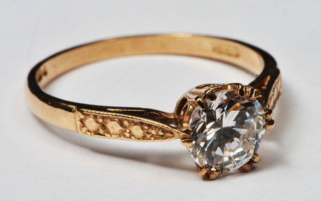 Appraisal: A CT GOLD RING with solitaire white stone setting