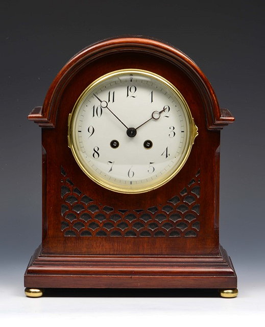 Appraisal: A MAHOGANY MANTEL CLOCK having a convex white enamel Arabic