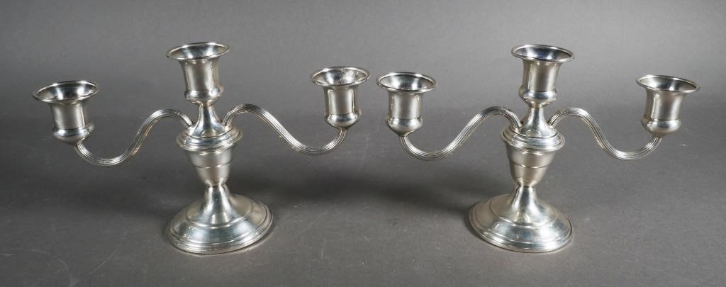 Appraisal: Two silver candlesticks marked sterling cement filled reinforced with rod