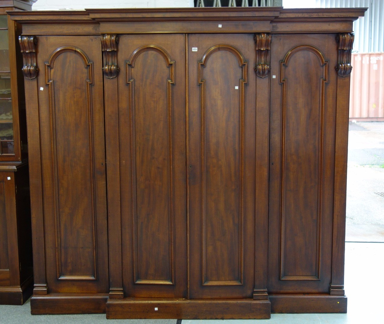 Appraisal: A Victorian mahogany four door breakfront wardrobe with acanthus scroll