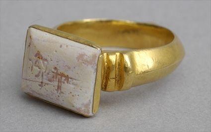 Appraisal: ISLAMIC SEAL RING Gold ring set with rectangular convex white