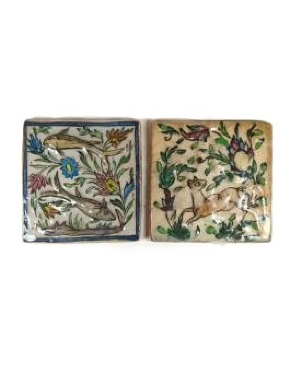 Appraisal: TWO PERSIAN FAIENCE HAND-PAINTED GLAZED DIMENSIONAL TILES VINING FLOWERS FISH