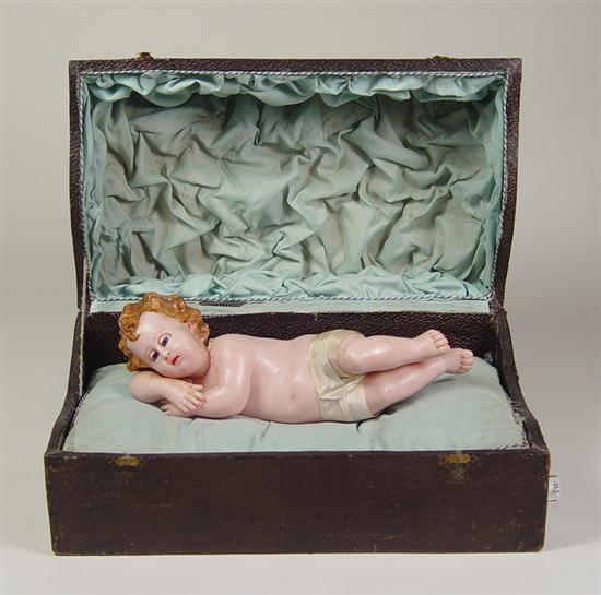 Appraisal: Wax Infant Figure in Music Box Wax figural of Christ