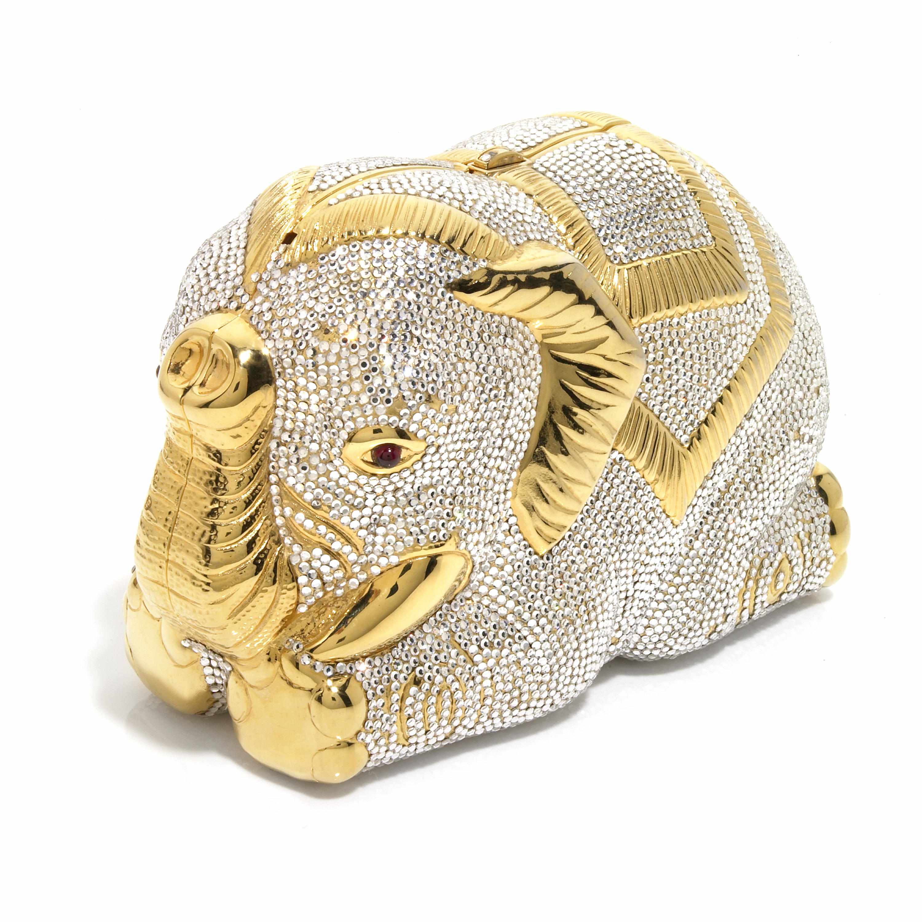 Appraisal: A silver crystal and gold colored metal laying down elephant