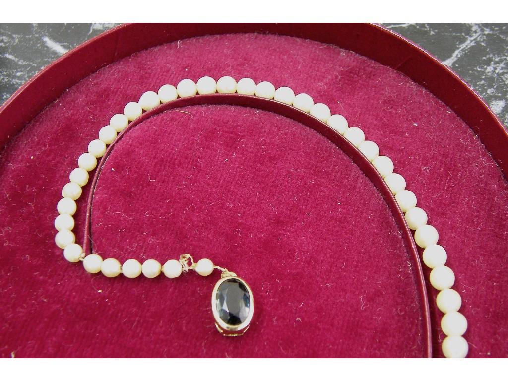 Appraisal: String of graduated cultured pearls with a blue gem set