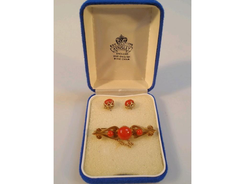 Appraisal: A Victorian coral set bar brooch and matching ear studs