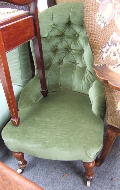 Appraisal: A Victorian button back nursing chair with turned supports raised