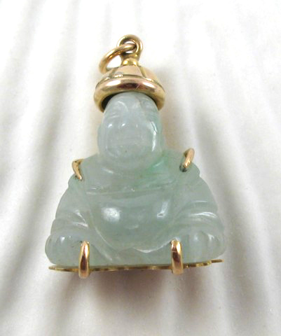 Appraisal: JADE AND FOURTEEN KARAT GOLD PENDANT The carved light green