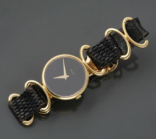 Appraisal: A k gold wristwatch with leather strap Piaget stirrup style