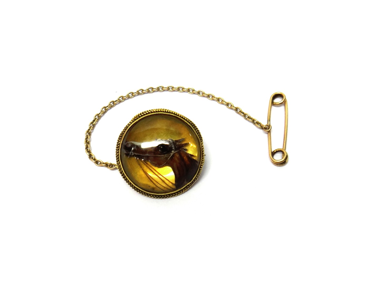 Appraisal: A gold mounted circular reverse painted intaglio crystal brooch designed