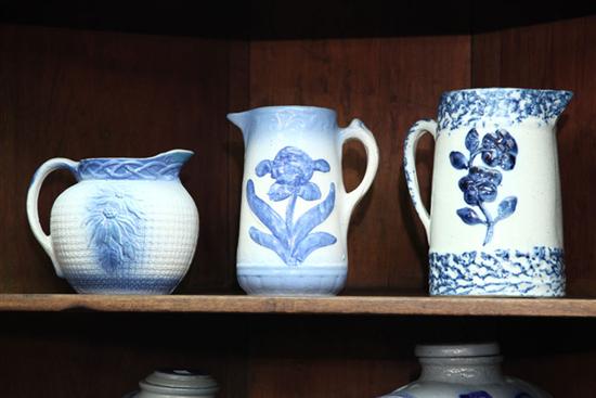 Appraisal: THREE BLUE AND WHITE STONEWARE PITCHERS White clay two tapered