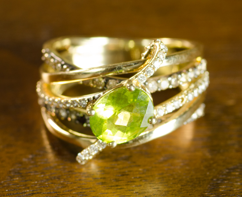 Appraisal: LE VIAN PERIDOT AND FOURTEEN KARAT GOLD RING with round