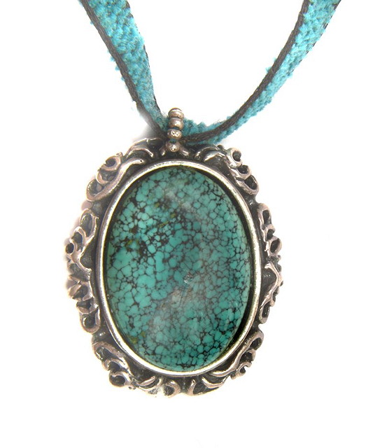 Appraisal: A SILVER AND TURQUOISE PENDANT of oval form and stylised