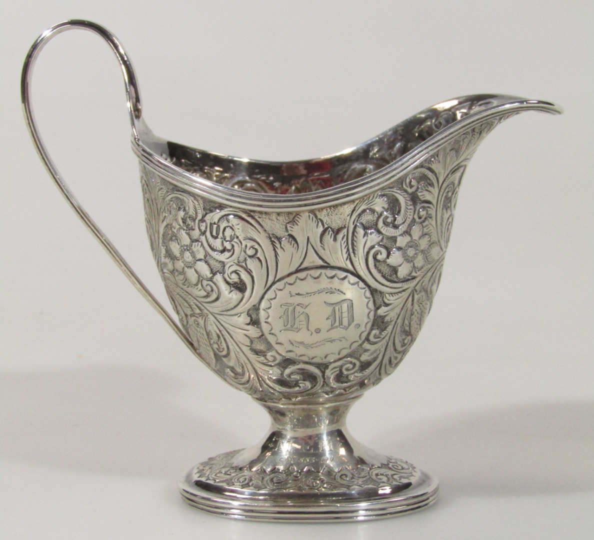 Appraisal: A Victorian silver cream jug the helmet shaped body heavily