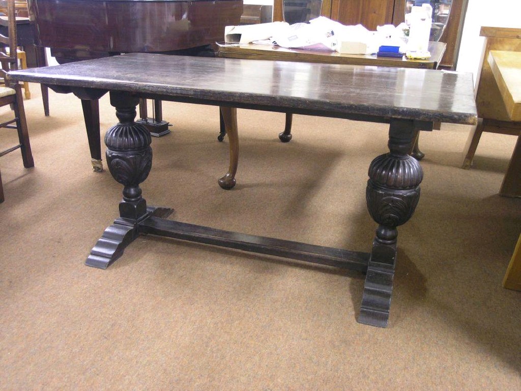 Appraisal: A solid dark oak refectory-type dining table rectangular top on